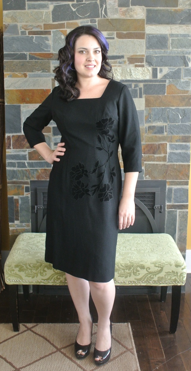 This black 60s wiggle dress is a beautiful lined wool with velvet flowers on the bodice.
