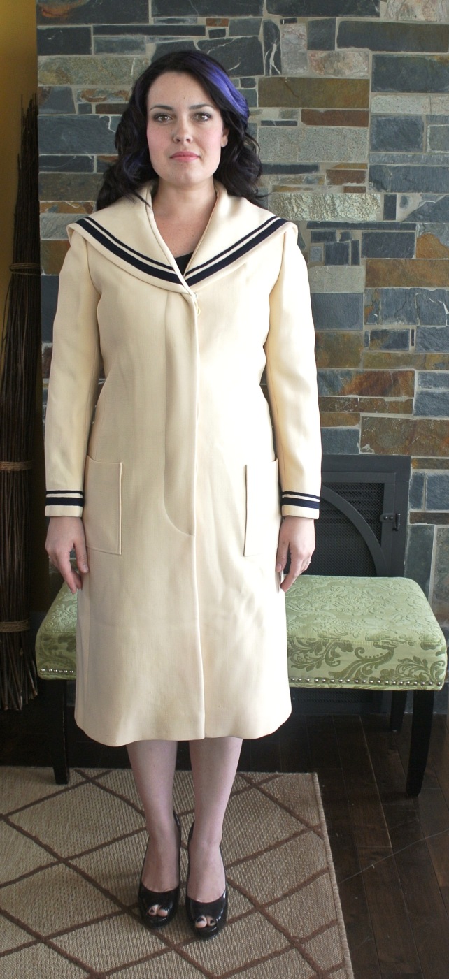 This is an amazing find!  Just under knee-length cream sailor coat with navy trim at the collar and wrists.  The coat is solidly constructed, 60s does 20s.